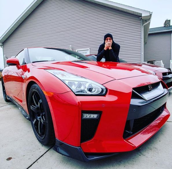 Shanna Riley's ex-husband Roman poses with his car