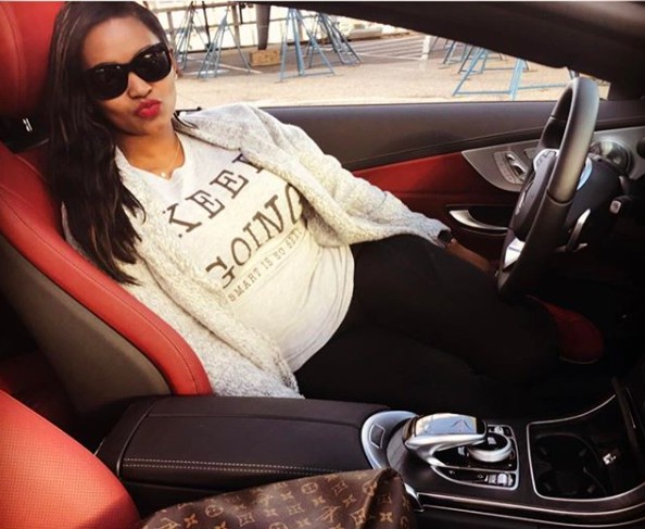 Teasha Bivins poses for a photo while sitting in the car