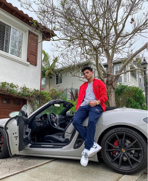 Ryan Garcia posing for photo while sitting outside of car