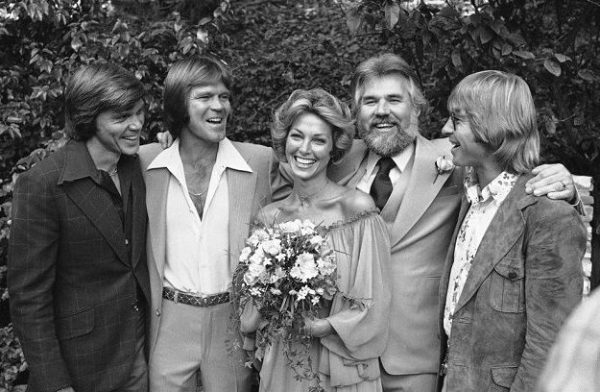 Marianne Gordon and her husband in their wedding dresses with their friends 
