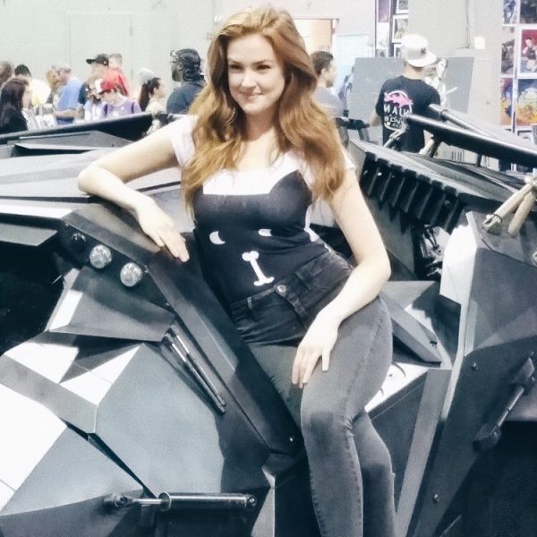 Maggie Geha poses for a photo with her car