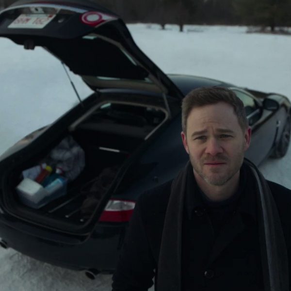 Aaron Ashmore standing outside his car 