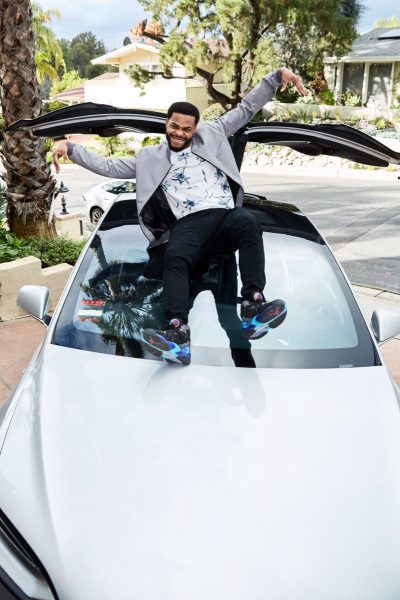 King Bach poses for a photo with his car