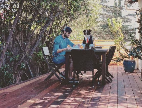 James Rafferty sitting at a table with his dog