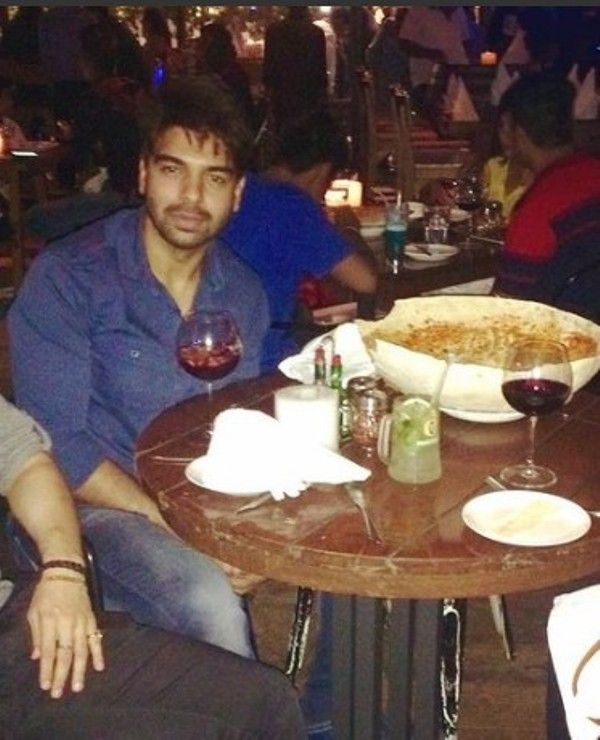 Vipul sitting with a glass of wine