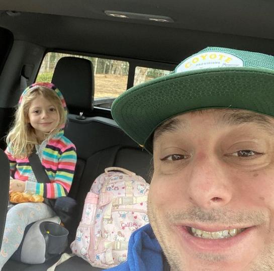 Petros Papadakis poses with his daughter in the car