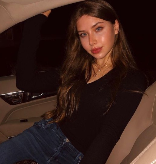Kiara Glasco posing in her car