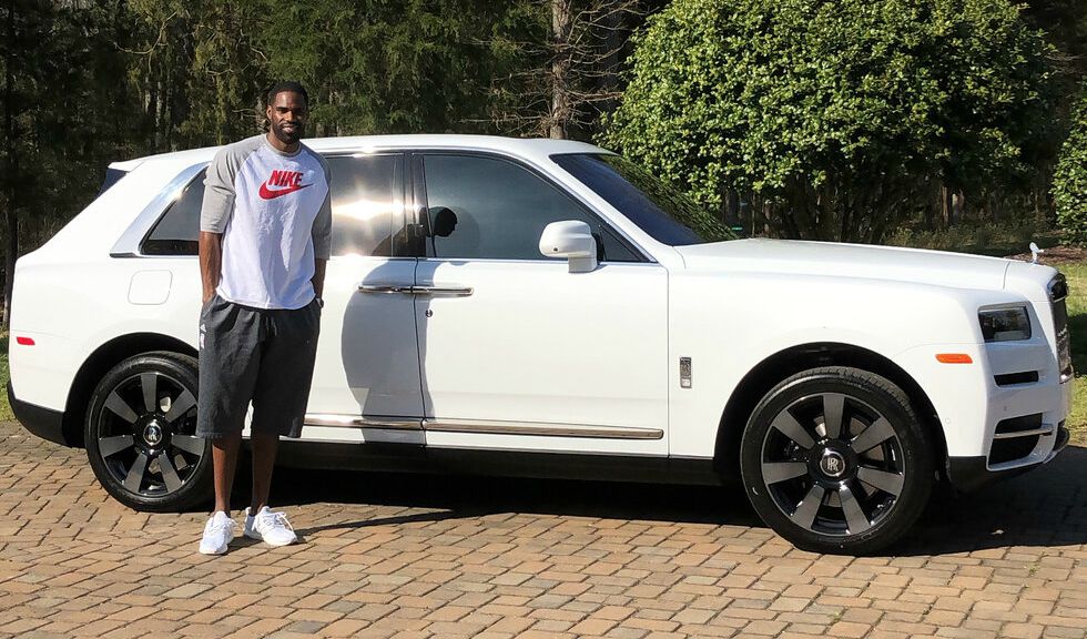 Antawn Jamison poses for a photo with his car