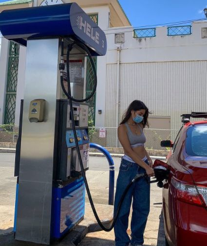 Kirsten Titus and her car at the gas station