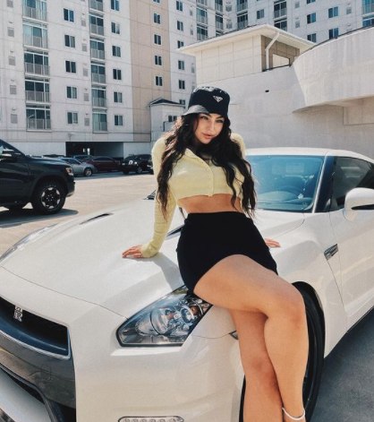Emily Rinaudo poses with her car