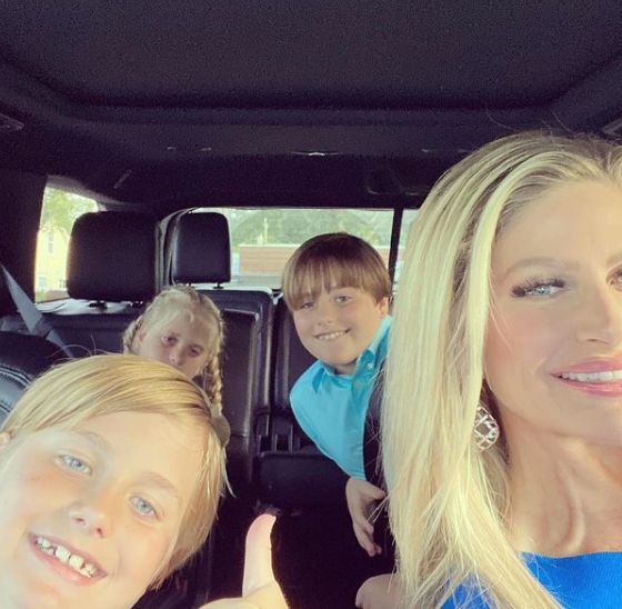 Martha Sugalski poses with her triplets in the car