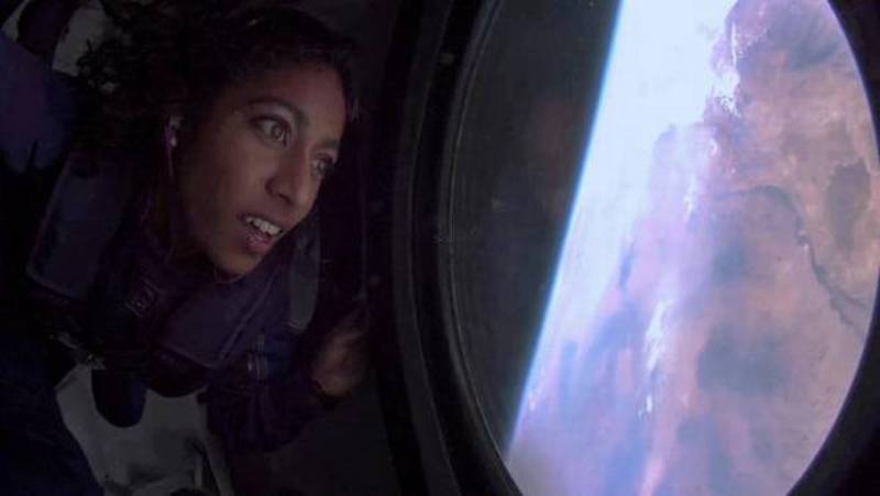 Sirisha Bandla looks out the window of Earth in zero gravity aboard Virgin Galactic's passenger rocket plane VSS Unity after reaching the edge of space on July 11, 2021