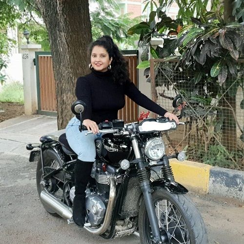 Shubha Poonja posing on a motorcycle