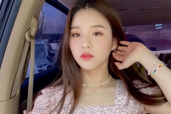 Hee Jin poses in the car