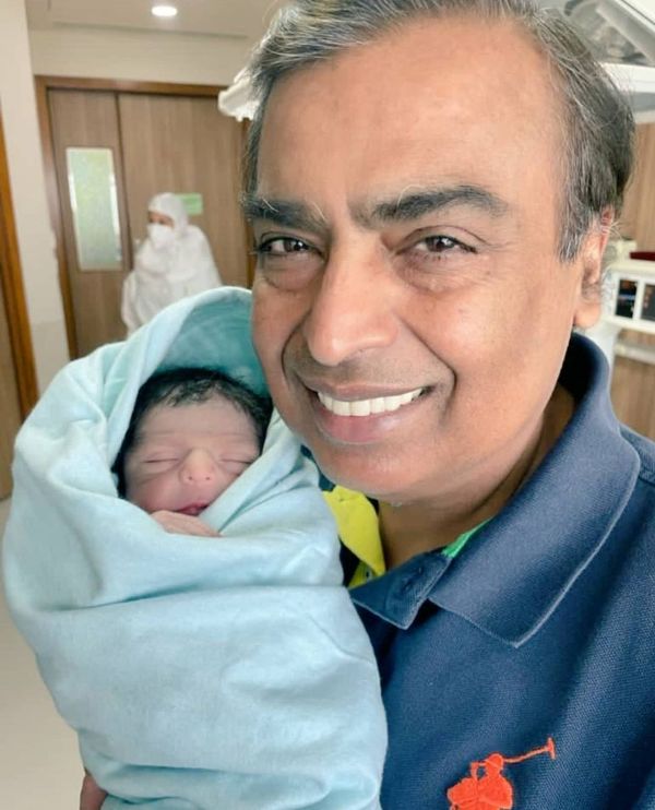 Mukesh Ambani holds newborn grandson