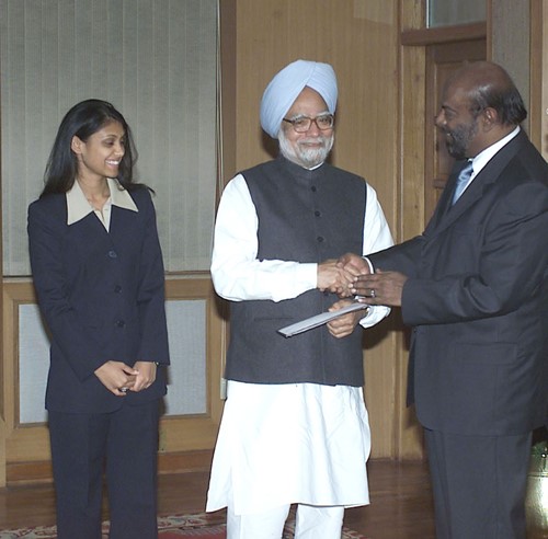 Shiv Nadar and his daughter Roshni Nadar hand over a cheque for the Prime Minister's Relief Fund