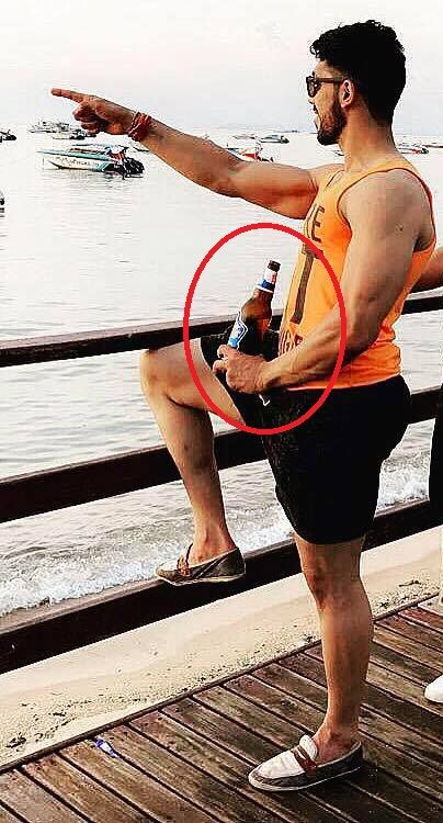 Shivashish Mishra holds a beer bottle