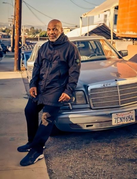 Mike Tyson poses for a photo with his car