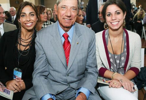 Olivia Namath clicks for a photo with her father and sister