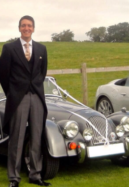 Oliver Phelps poses with the car